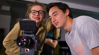 Two students looking through a RED camera
